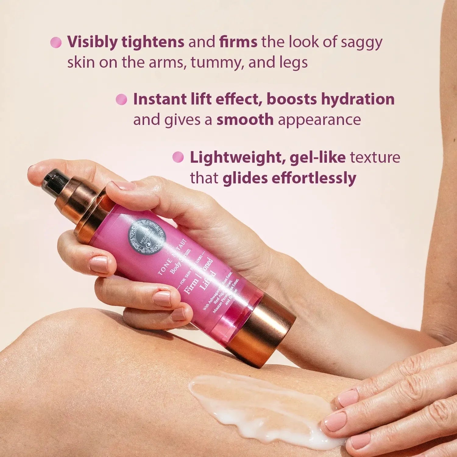 Tone N Taut Body Serum: a hand holding the bottle while another hand spreads the white serum on a leg. Visibly tightens and firms the look of saggy skin on the arms, tummy, and legs. Instant lift effect, boosts hydration and gives a smooth appearance. Lightweight, gel-like texture that glides effortlessly